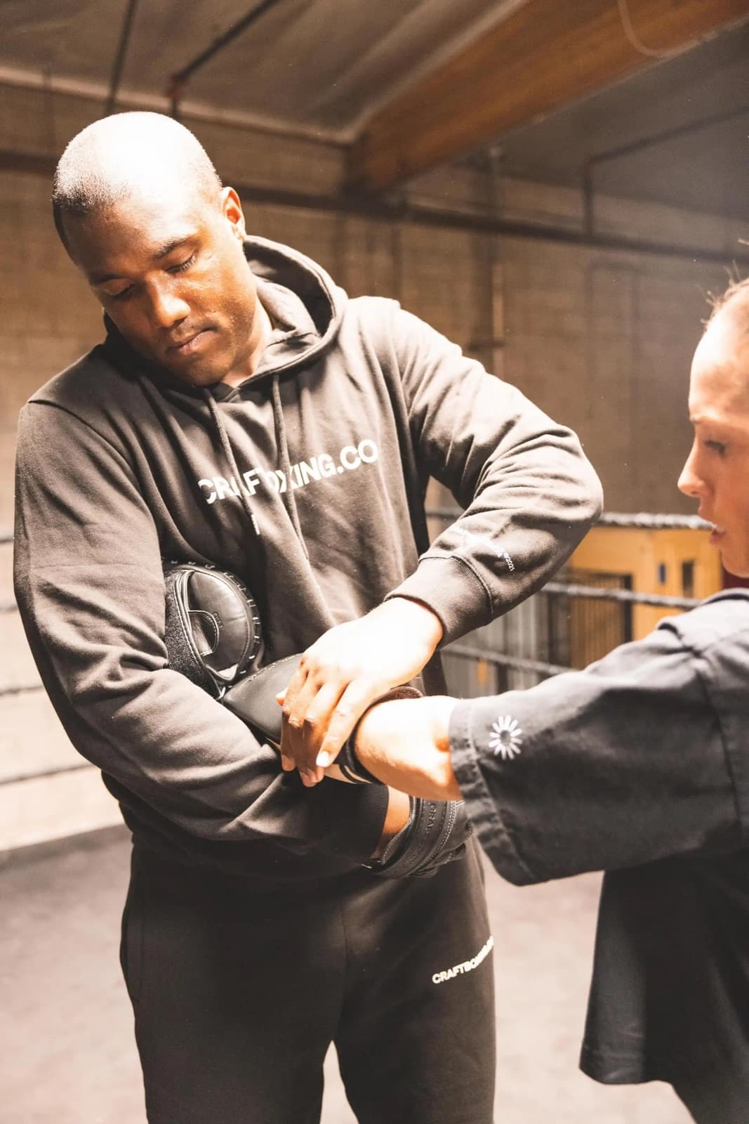Coach wrapping a young boxer's hands