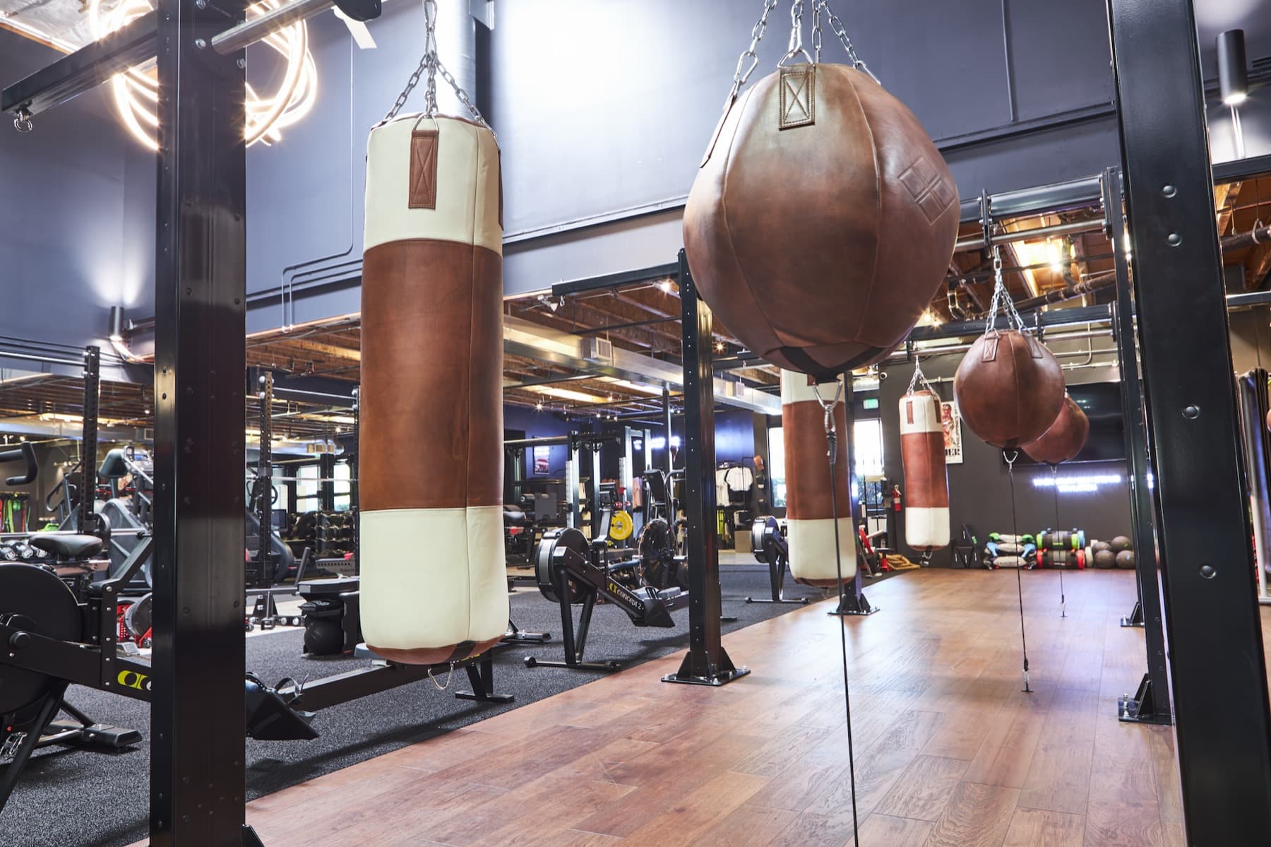 Leather heavy bags and uppercut bag on the bag floor at Craft Boxing Club Calabasas